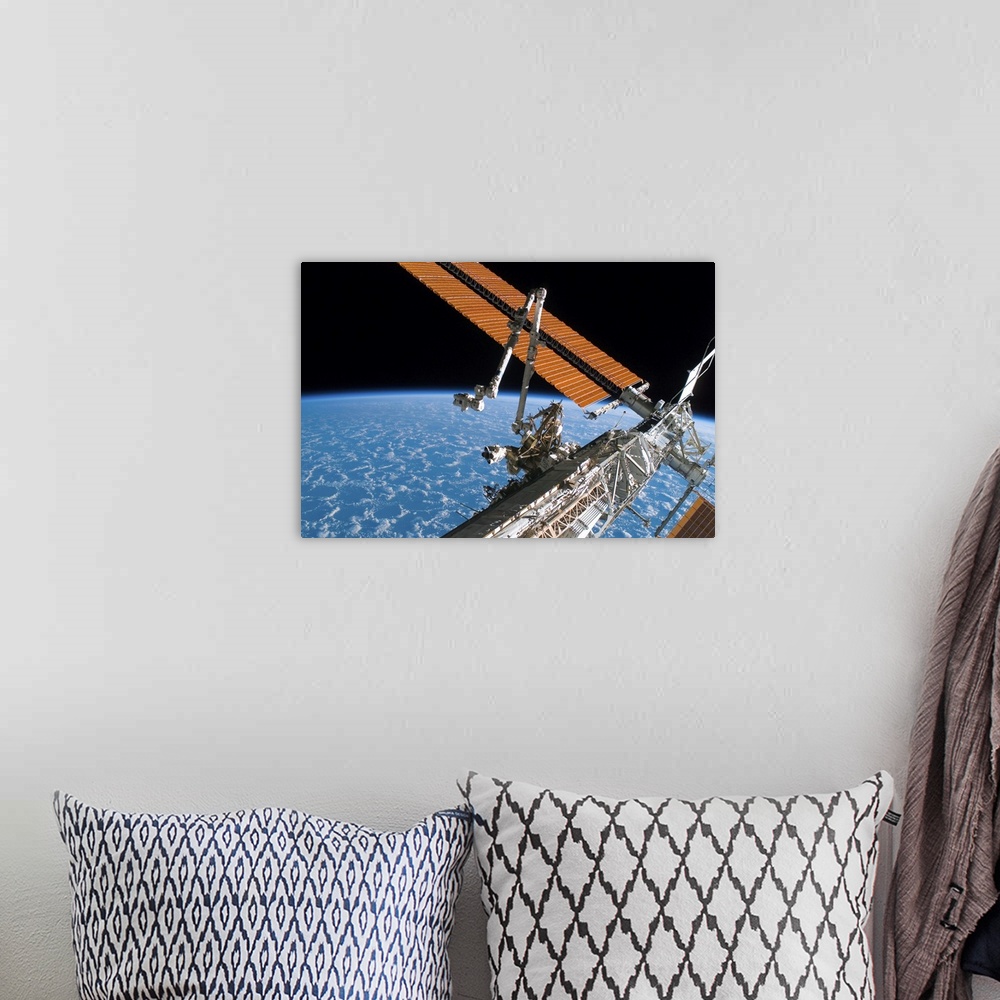 A bohemian room featuring The Canadarm2 and solar array panel wings on the International Space Station