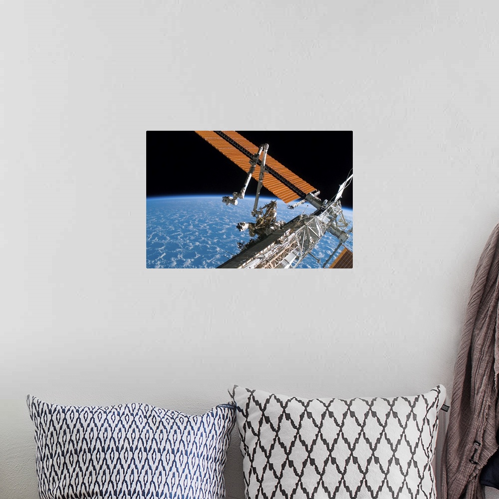 A bohemian room featuring The Canadarm2 and solar array panel wings on the International Space Station