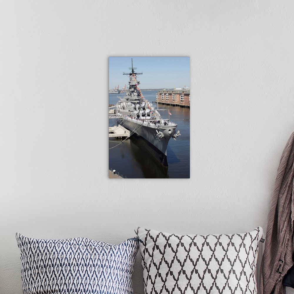 A bohemian room featuring The decommissioned US Navy Battleship USS Wisconsin berthed to the pier