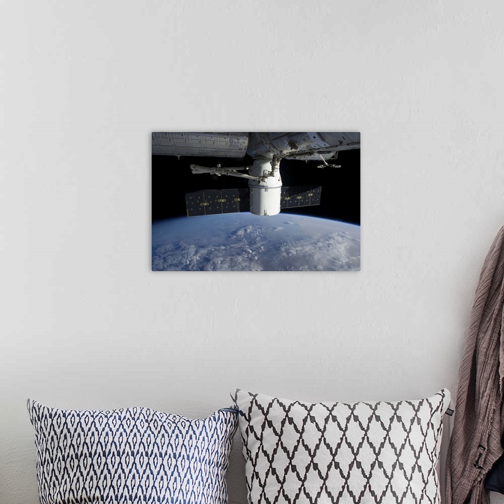 A bohemian room featuring March 3, 2013 - The docking of SpaceX Dragon to the International Space Station above a cloud cov...