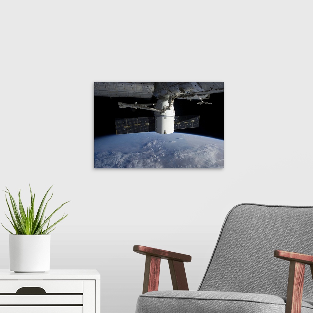 A modern room featuring March 3, 2013 - The docking of SpaceX Dragon to the International Space Station above a cloud cov...