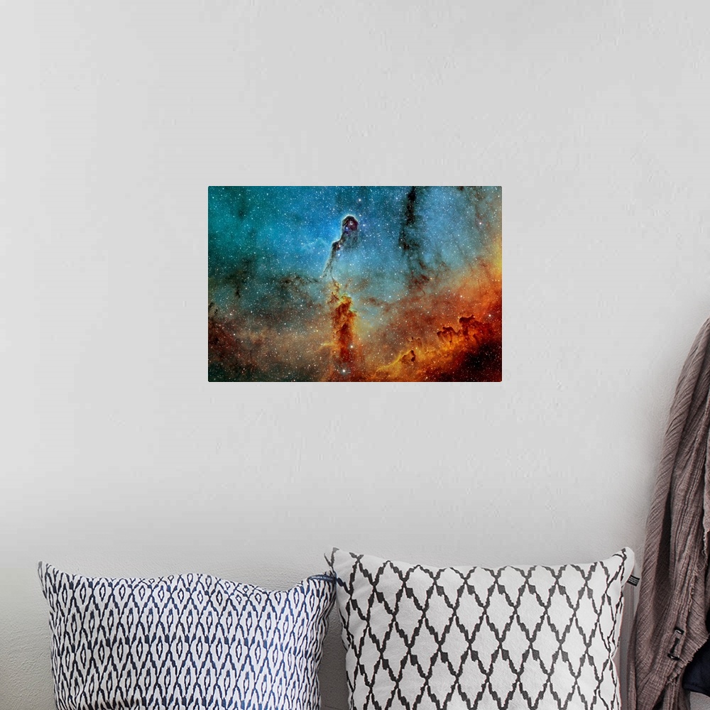 A bohemian room featuring Large photograph showcases a concentration of interstellar gas and dust within the much larger io...