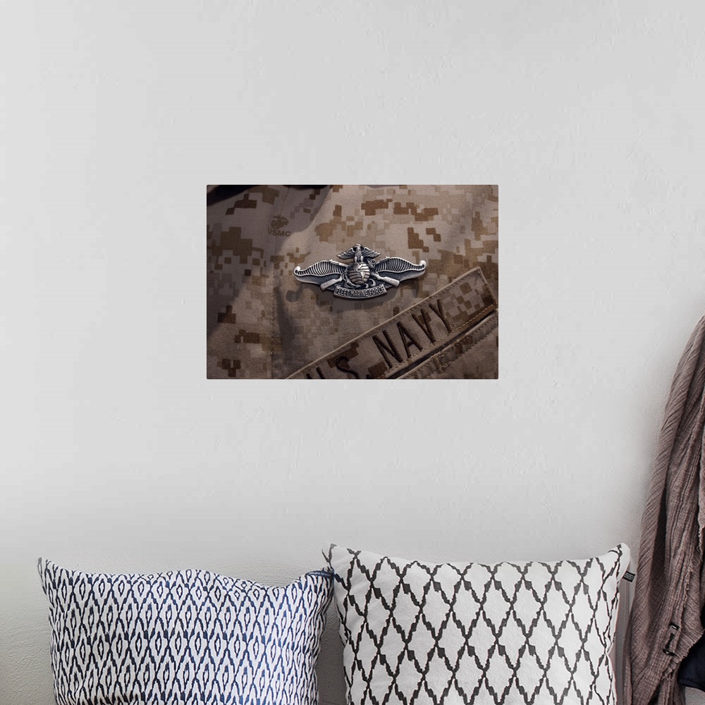 A bohemian room featuring The Enlisted Fleet Marine Force Warfare Specialist pin.