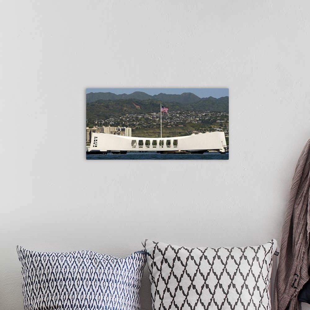 A bohemian room featuring The Ensign flies over the Arizona Memorial