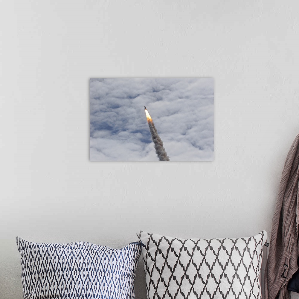 A bohemian room featuring July 8, 2011 - Space shuttle Atlantis just before it disappears into the clouds, Cape Canaveral, ...