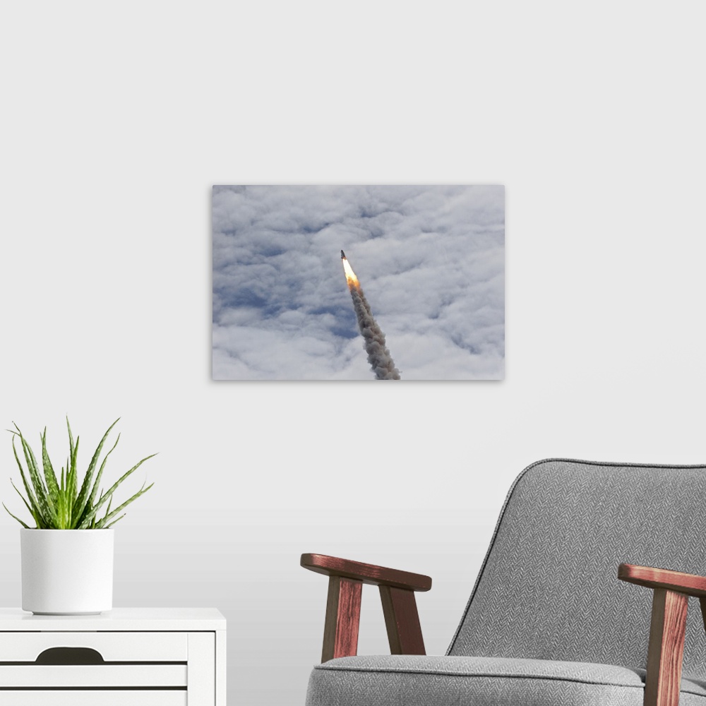 A modern room featuring July 8, 2011 - Space shuttle Atlantis just before it disappears into the clouds, Cape Canaveral, ...