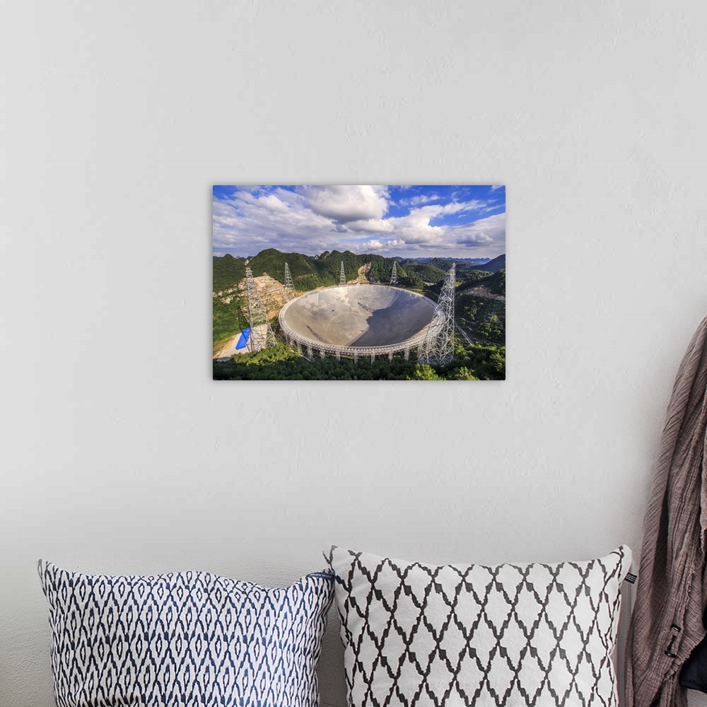 A bohemian room featuring The Five-hundred-meter Aperture Spherical Telescope is nestled within a natural basin in China.