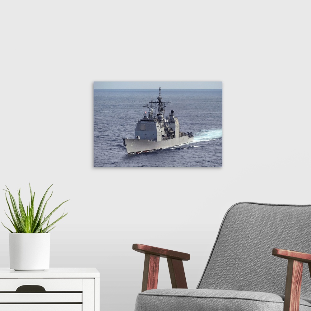 A modern room featuring The guided missile cruiser USS Cowpens.