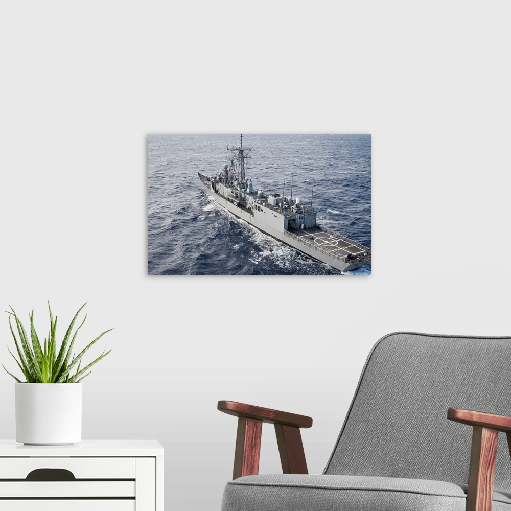 A modern room featuring The guided-missile frigate USS Reuben James.