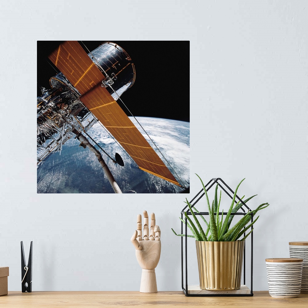 A bohemian room featuring April 25, 1990 - The Hubble Space Telescope backdropped by planet Earth.