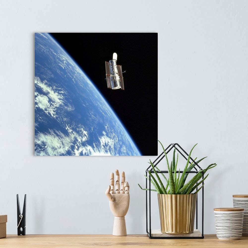 A bohemian room featuring The Hubble Space Telescope with a blue earth in the background