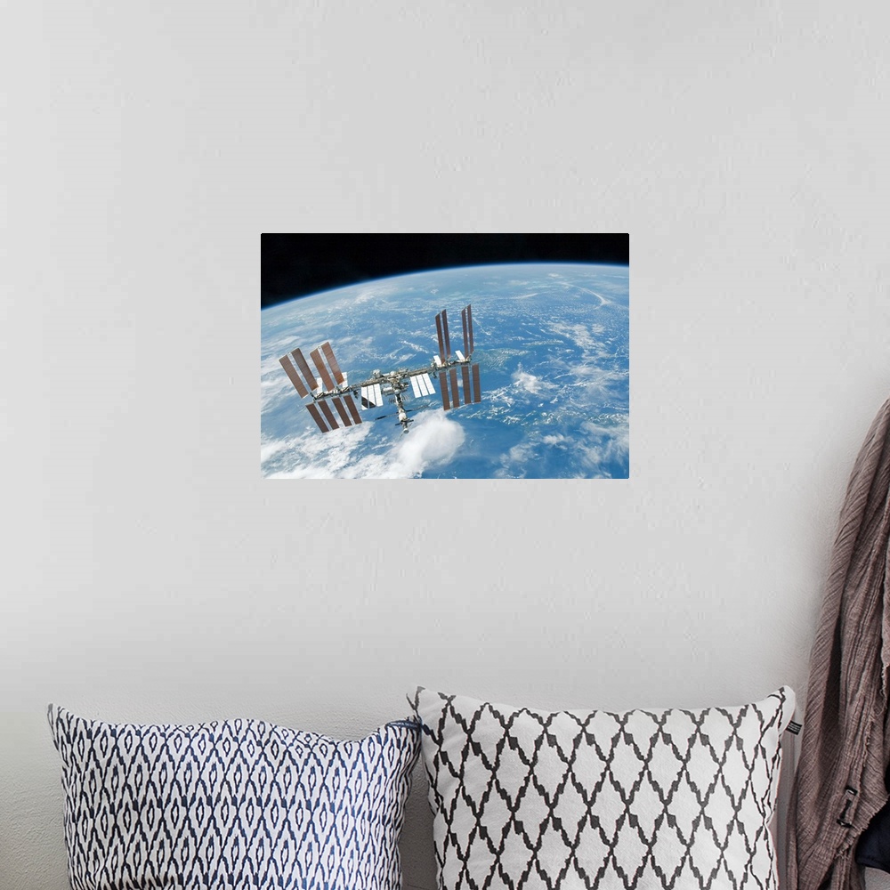 A bohemian room featuring The International Space Station backdropped by Earths horizon