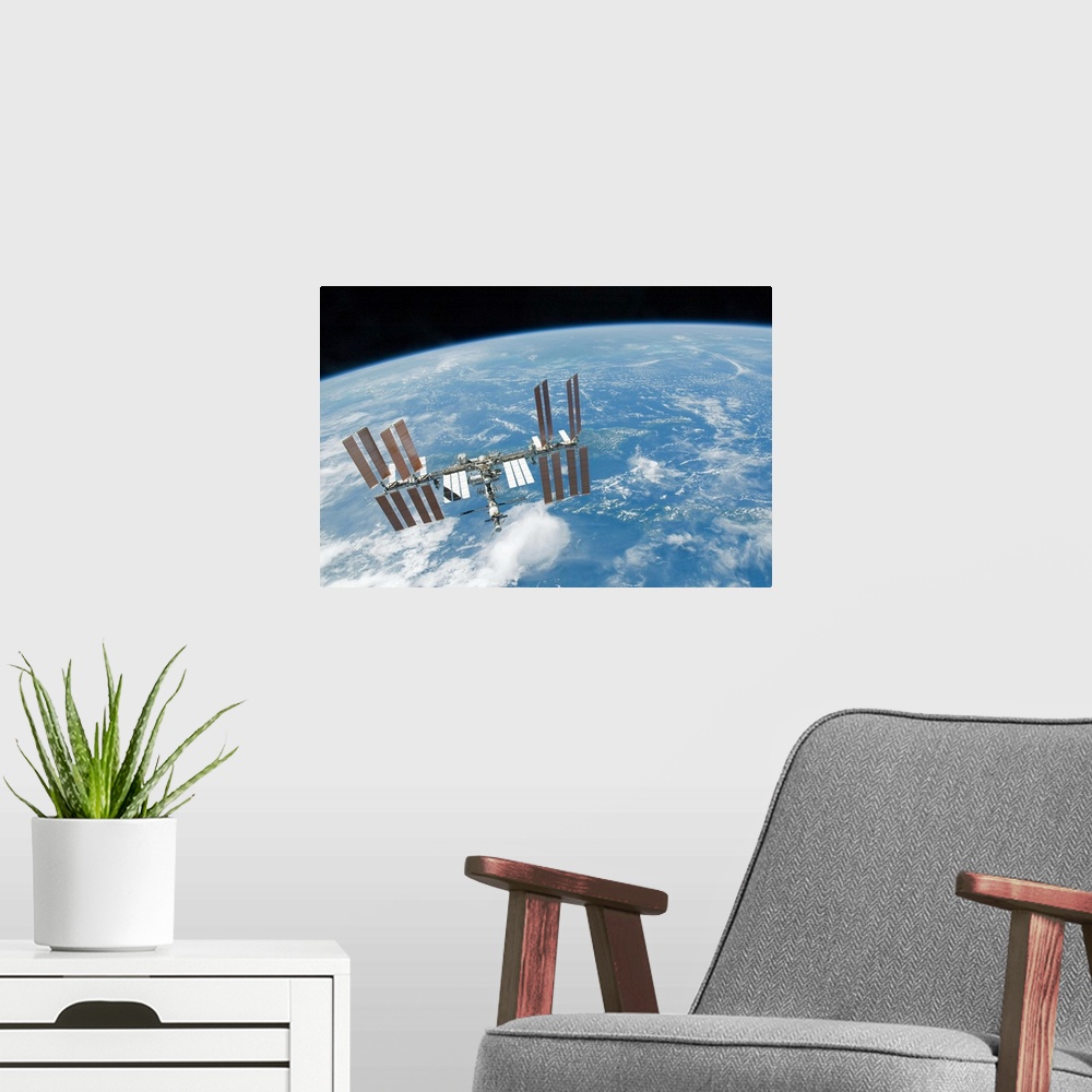 A modern room featuring The International Space Station backdropped by Earths horizon