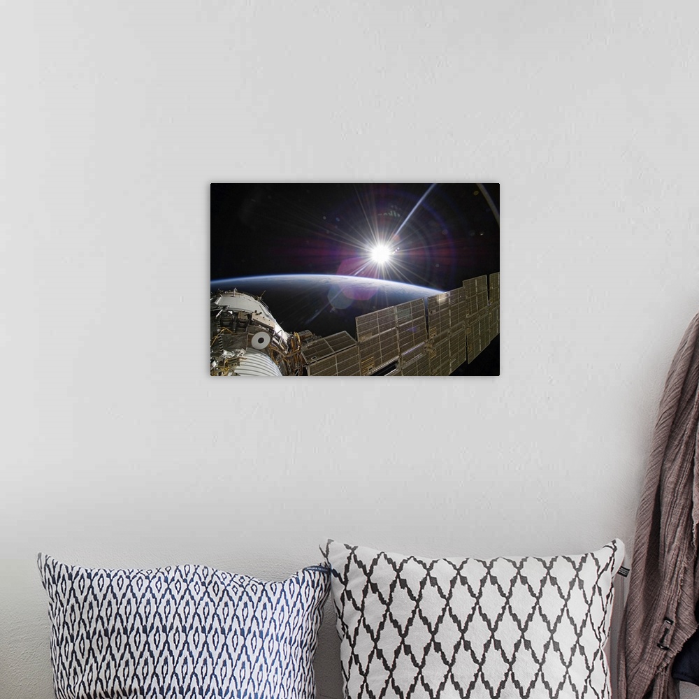 A bohemian room featuring The International Space Station backdropped by the bright Sun over Earths horizon