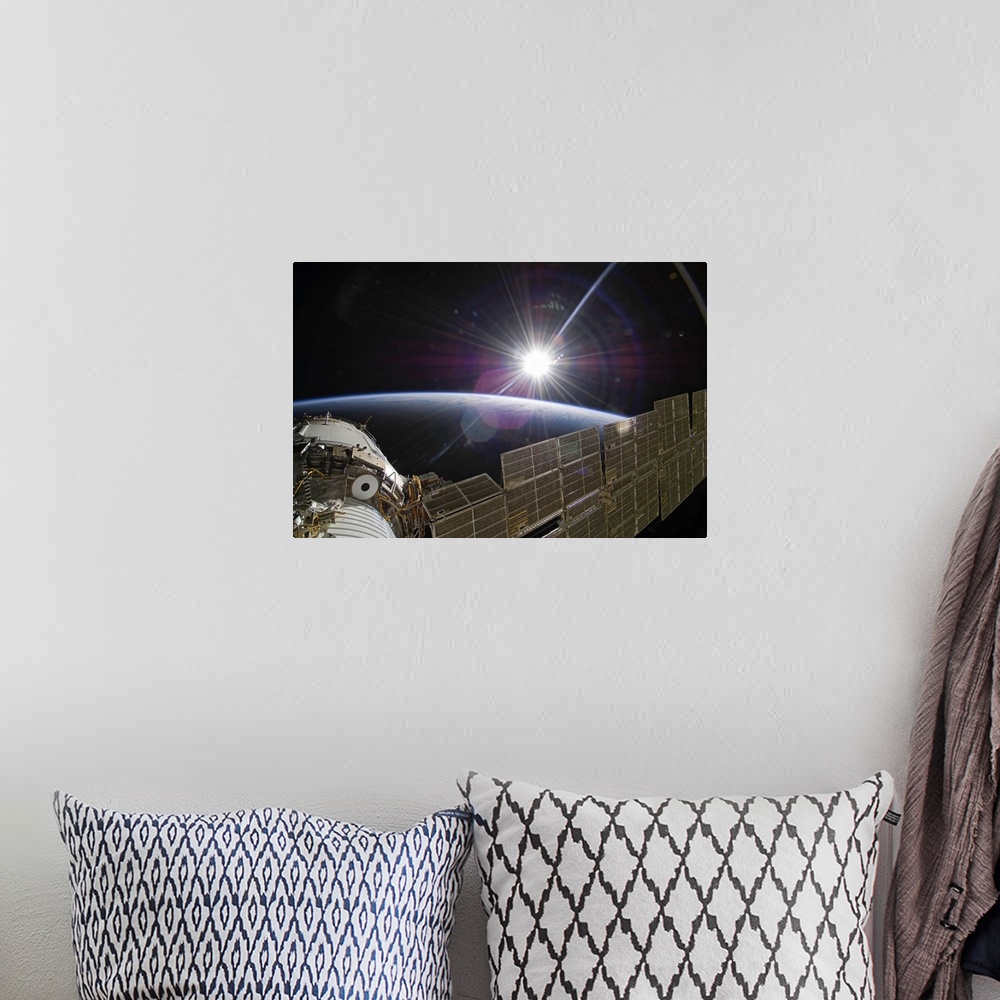 A bohemian room featuring The International Space Station backdropped by the bright Sun over Earths horizon