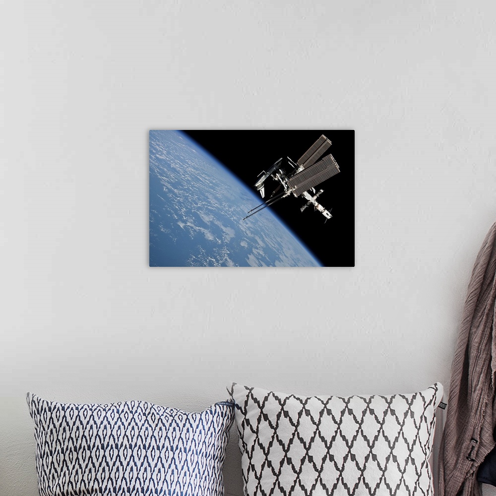 A bohemian room featuring May 23, 2011 - The International Space Station and docked Space Shuttle Endeavour, backdropped by...