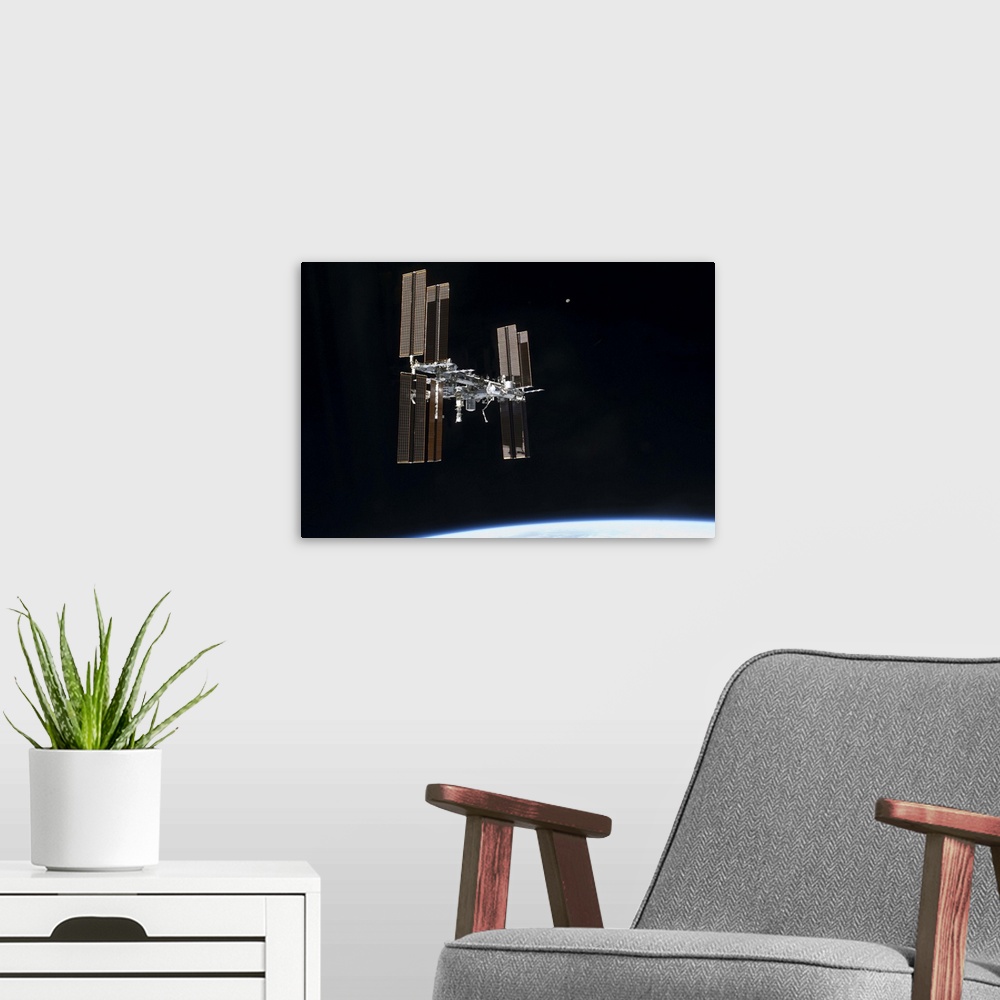 A modern room featuring July 19, 2011 - The International Space Station in orbit above Earth.