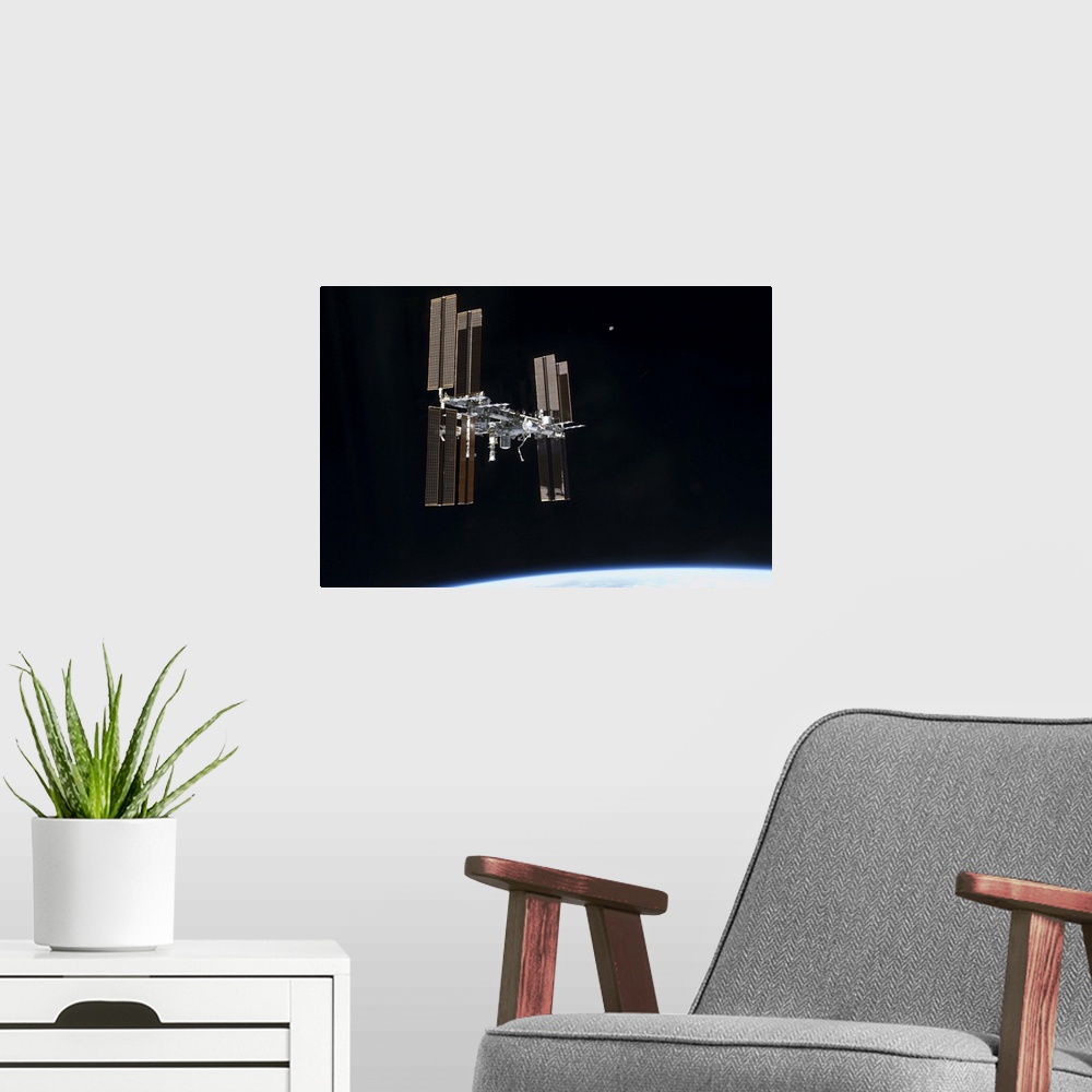 A modern room featuring July 19, 2011 - The International Space Station in orbit above Earth.