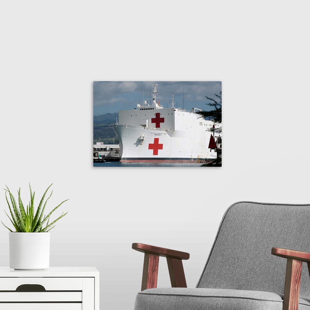 A modern room featuring The Military Sealift Command hospital ship USNS Mercy moored in Pearl Harbor