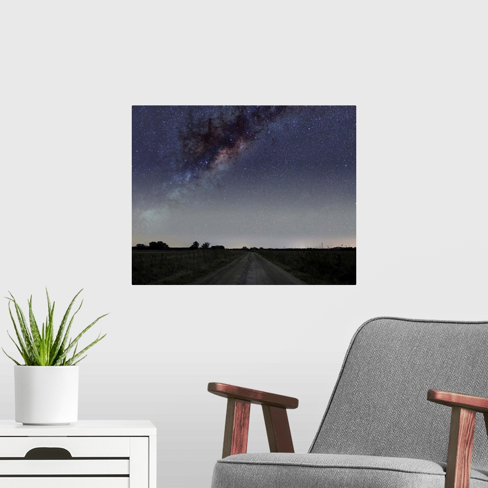 A modern room featuring The center of the Milky Way galaxy over a rural road in Mercedes, Argentina.