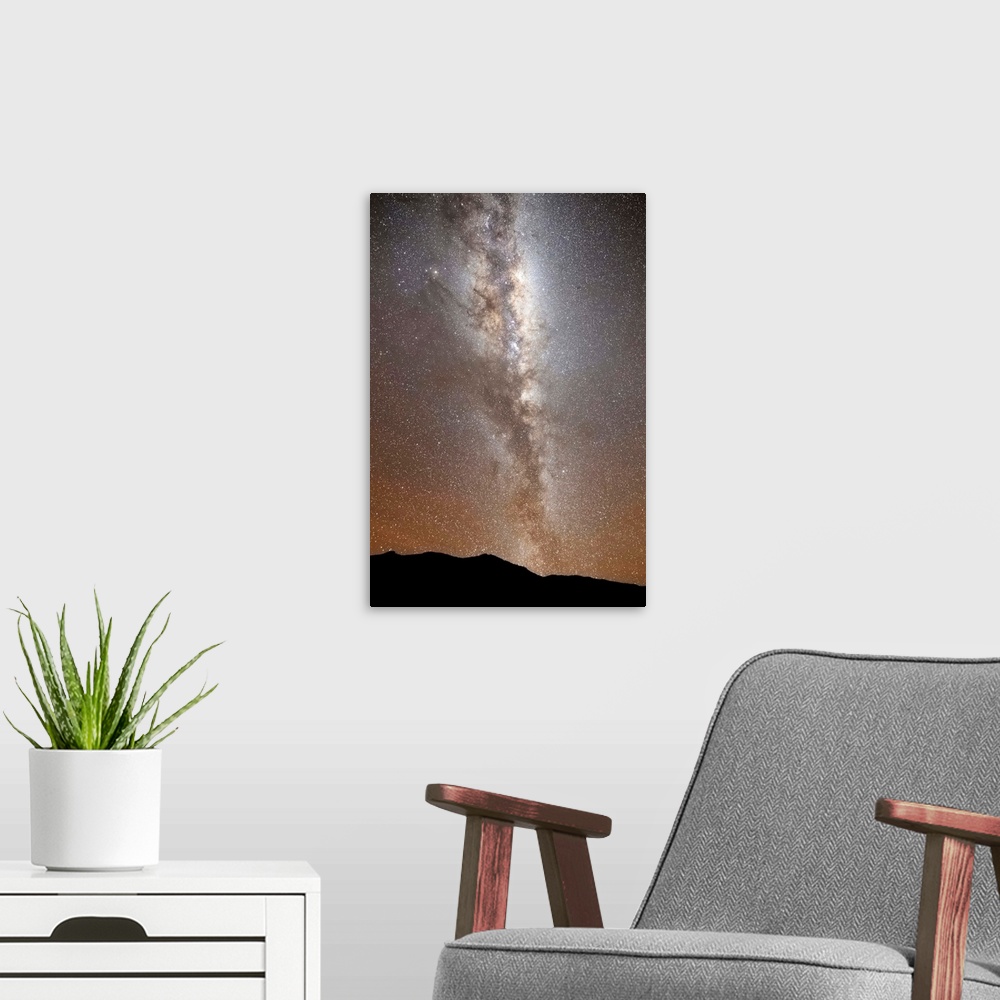 A modern room featuring The Milky Way in vertical position rising from the horizon, Sierra de la Ventana, Argentina.
