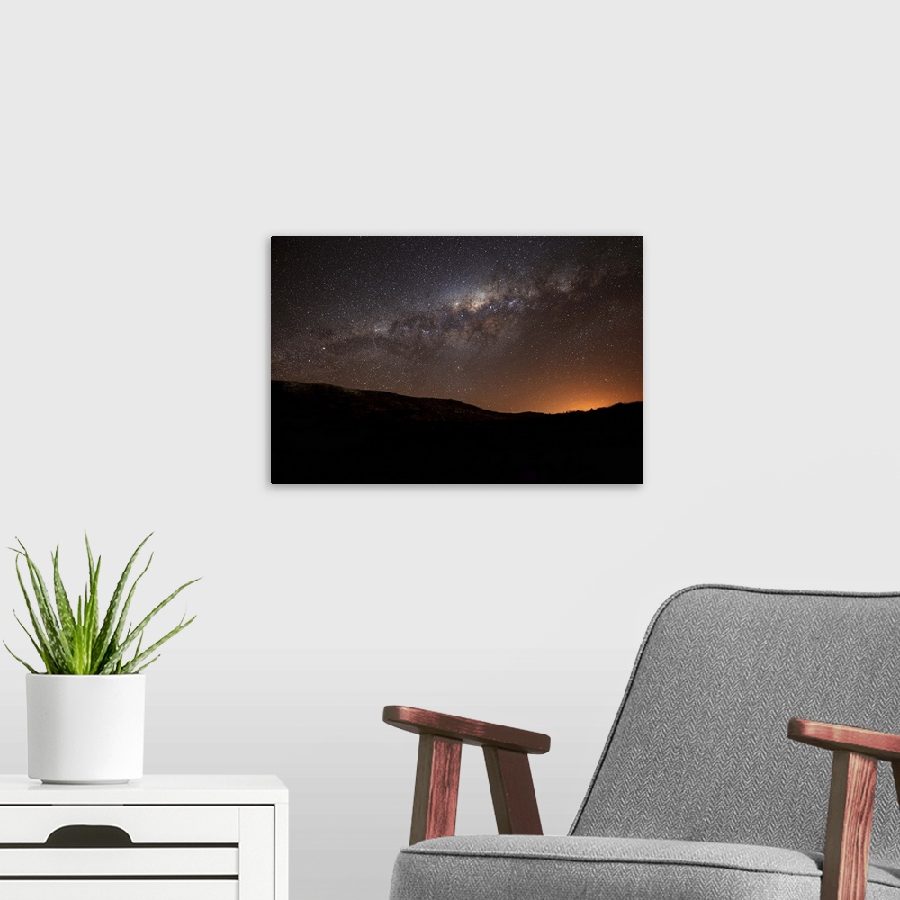 A modern room featuring The Milky Way setting behind the hills of Azul, Argentina, part of the Tandilia Hills. The light ...