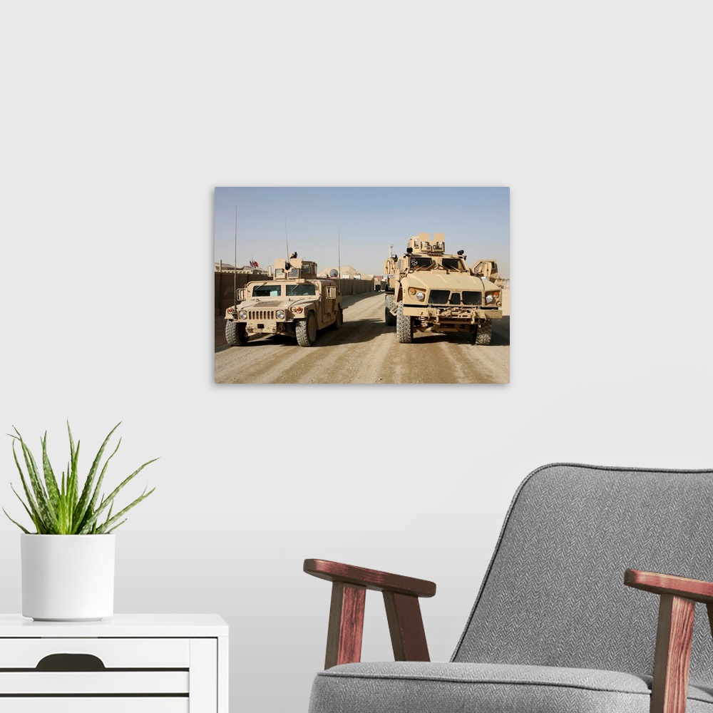 A modern room featuring The Mine Resistant Ambush Protected All Terrain Vehicle and its predecessor, the humvee.