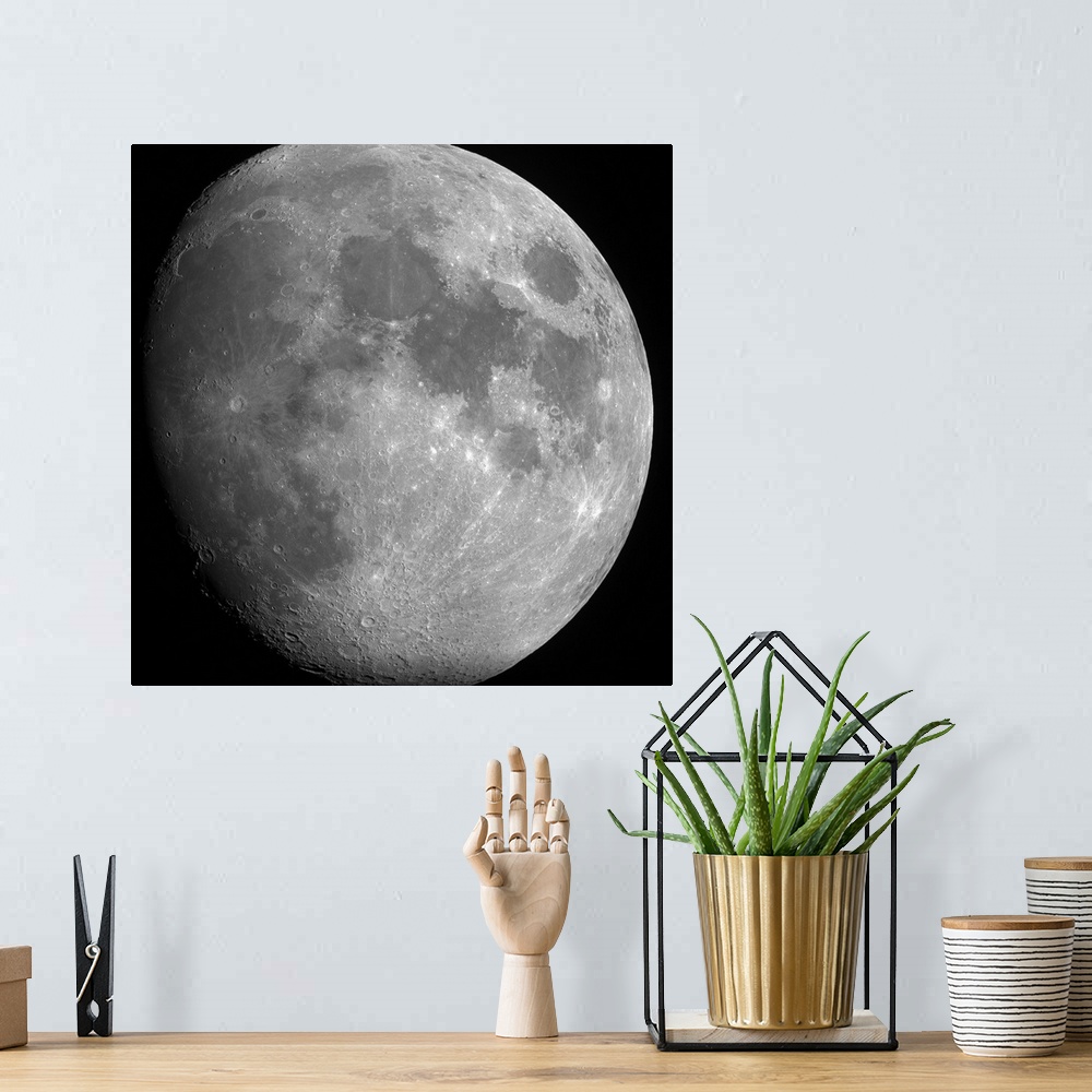 A bohemian room featuring Close up photo of the entire moon with its visible craters and dark spots.