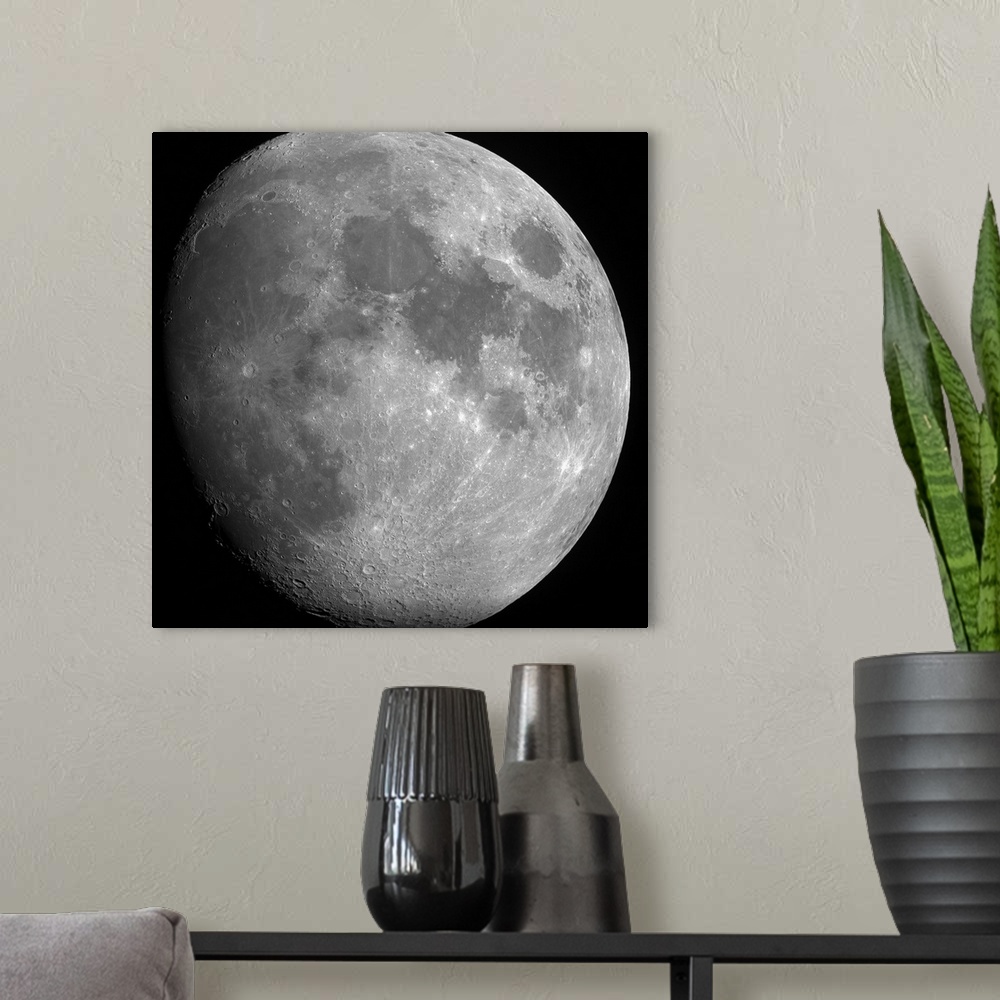A modern room featuring Close up photo of the entire moon with its visible craters and dark spots.