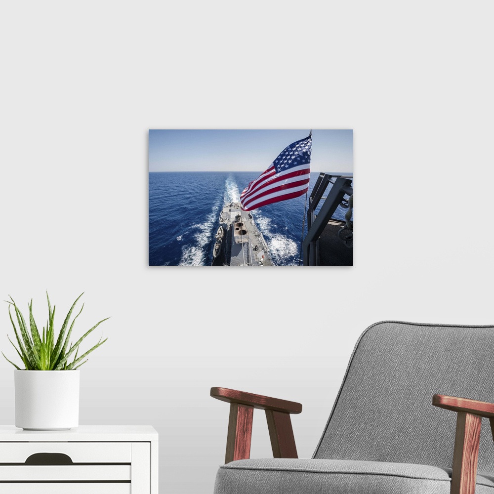 A modern room featuring May 23, 2013 - The national ensign flies from the mast aboard the guided-missile destroyer USS St...
