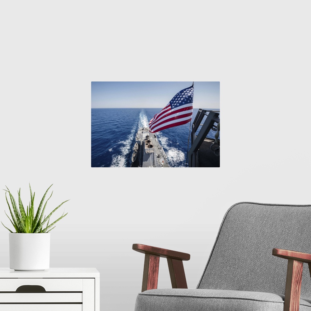 A modern room featuring May 23, 2013 - The national ensign flies from the mast aboard the guided-missile destroyer USS St...