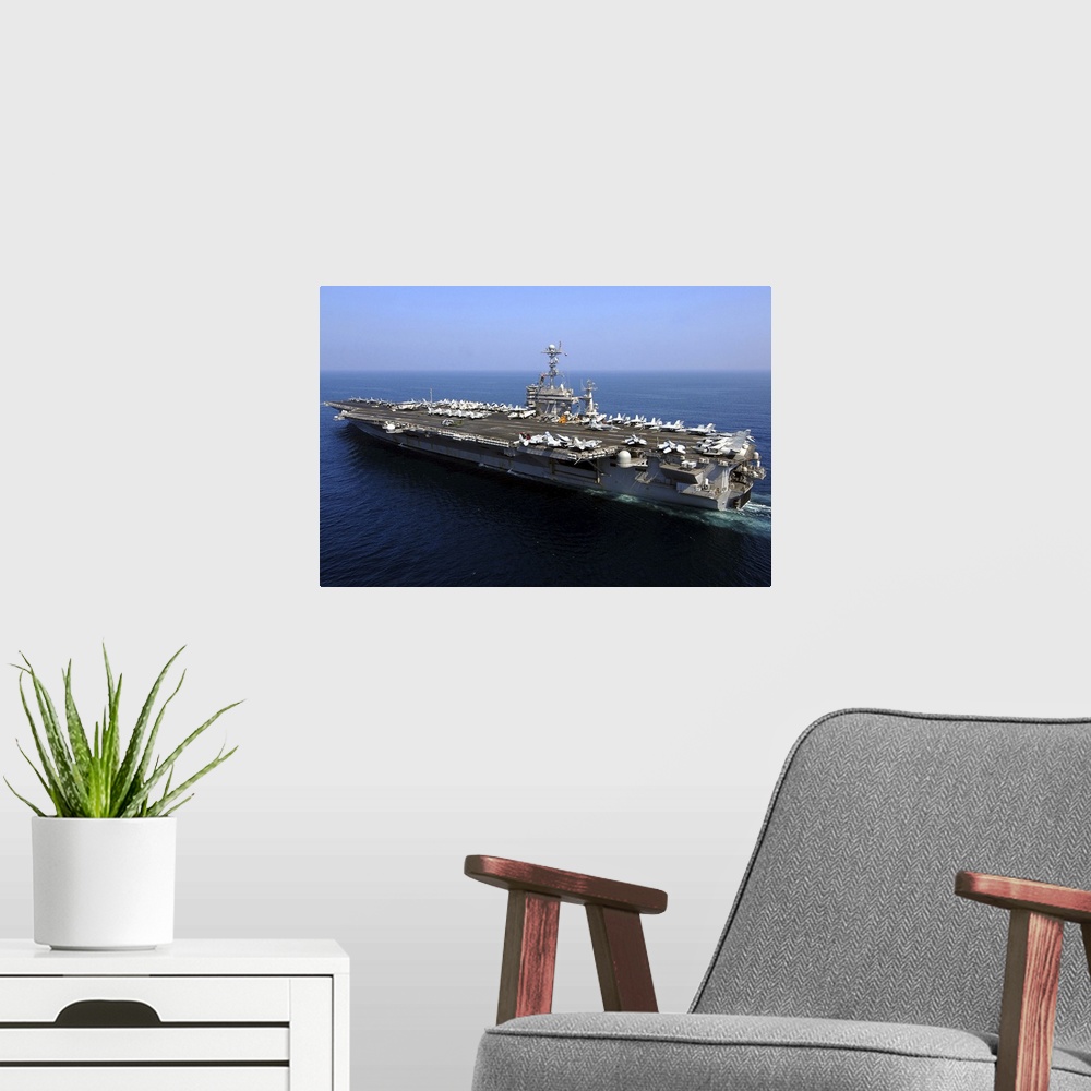 A modern room featuring The Nimitz-class aircraft carrier USS John C. Stennis.