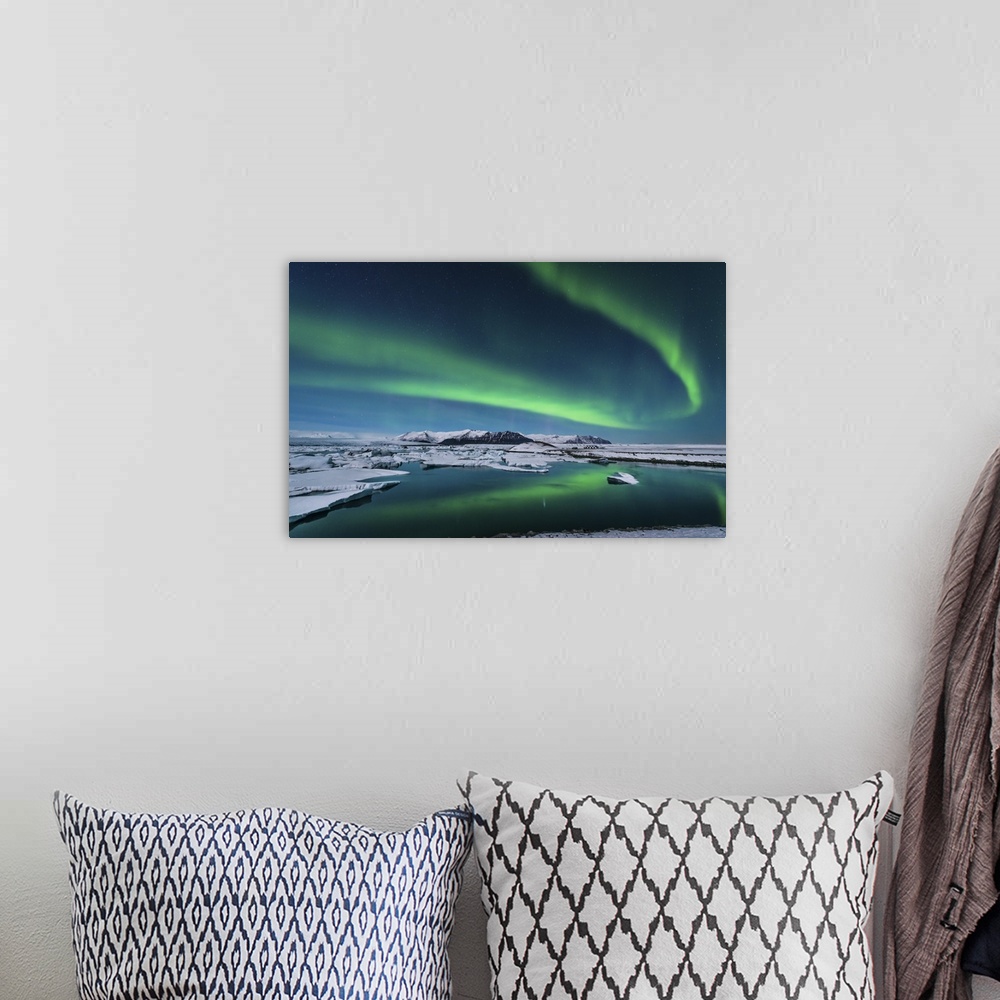 A bohemian room featuring The northern lights dance over the glacier lagoon in Iceland.