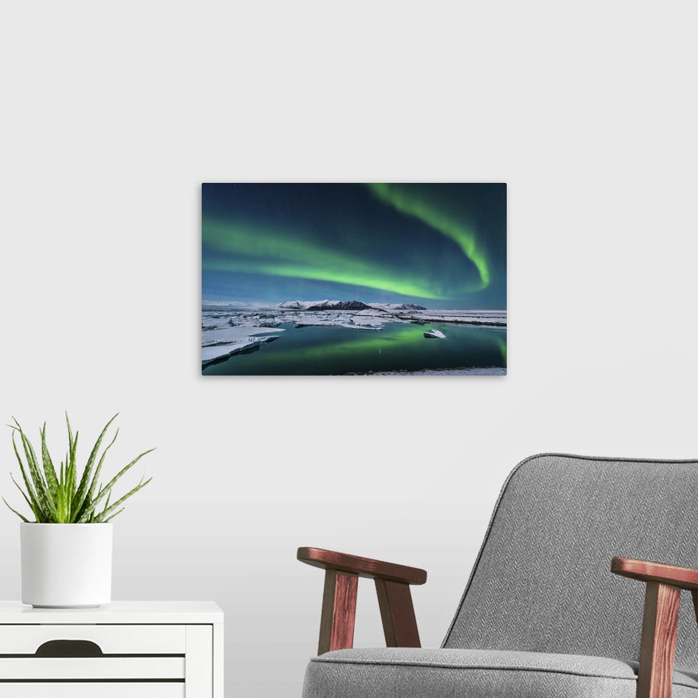 A modern room featuring The northern lights dance over the glacier lagoon in Iceland.