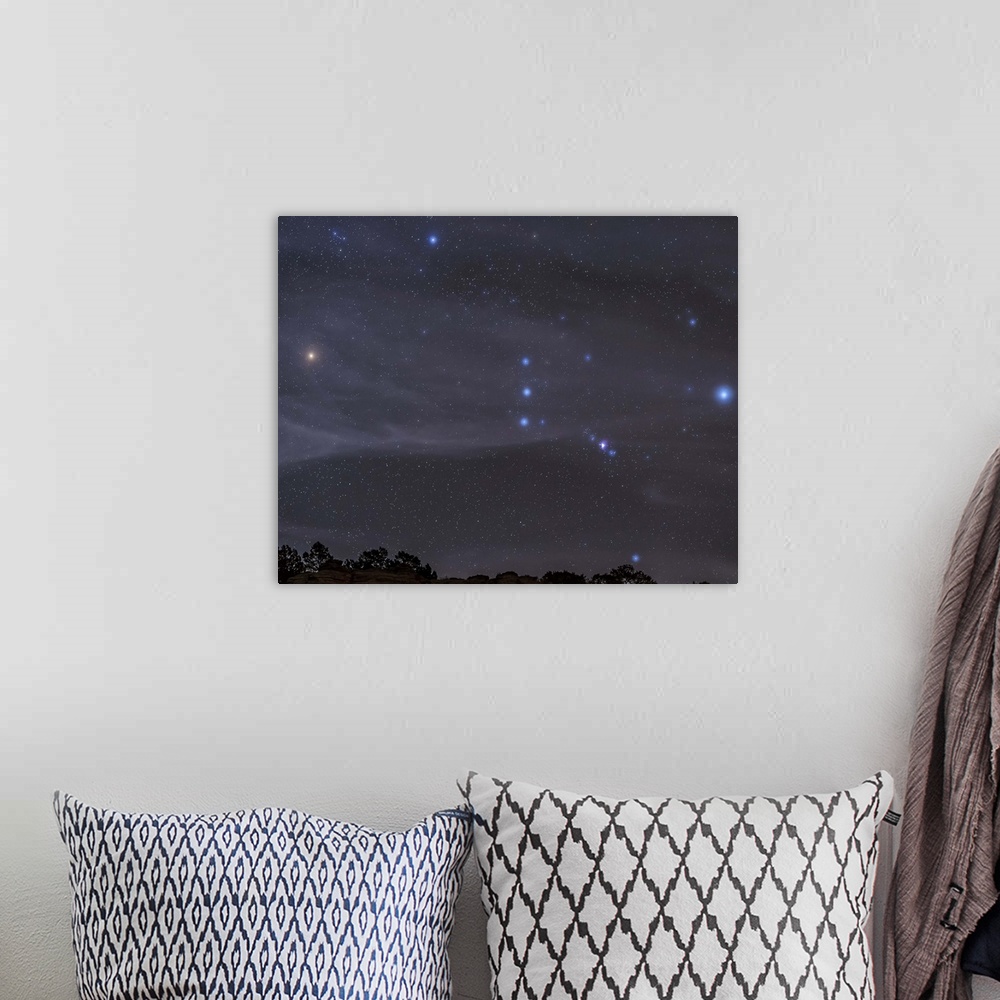 A bohemian room featuring The Orion constellation rises over a hill through high thin clouds near Black Mesa, Oklahoma.