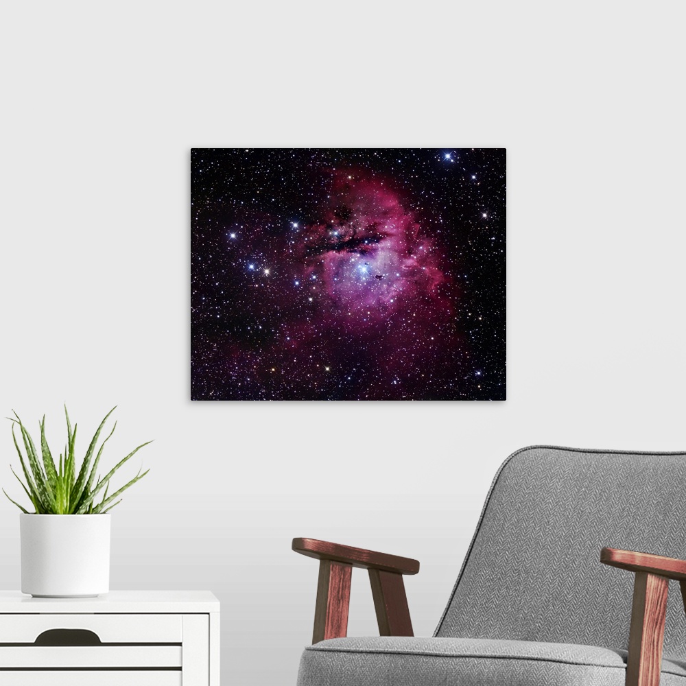 A modern room featuring The Pacman Nebula, also known as NGC 281, is an H II region in the constellation of Cassiopeia an...