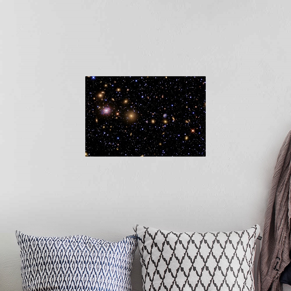 A bohemian room featuring This large piece of artwork is a picture of the galaxy with a variety of stars in different sizes...