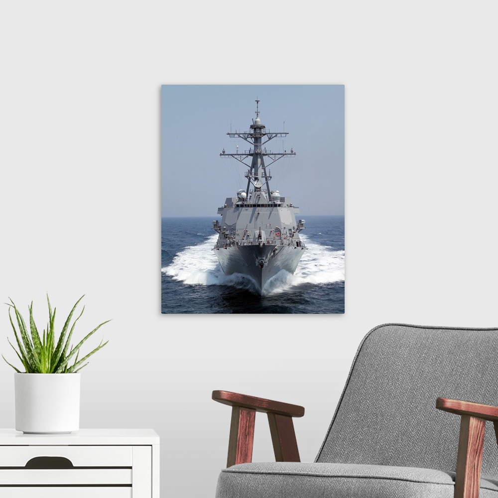 A modern room featuring The Pre-Commissioning Unit guided missile destroyer USS Forrest Sherman.