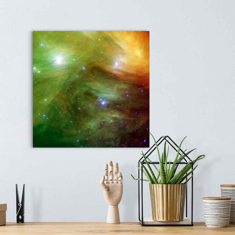 A bohemian room featuring Big square canvas art of a vividly colored solar system with stars of various sizes.