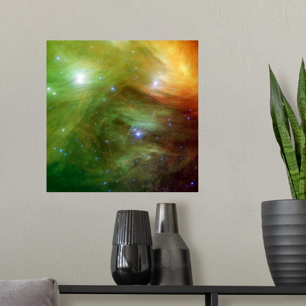 A modern room featuring Big square canvas art of a vividly colored solar system with stars of various sizes.
