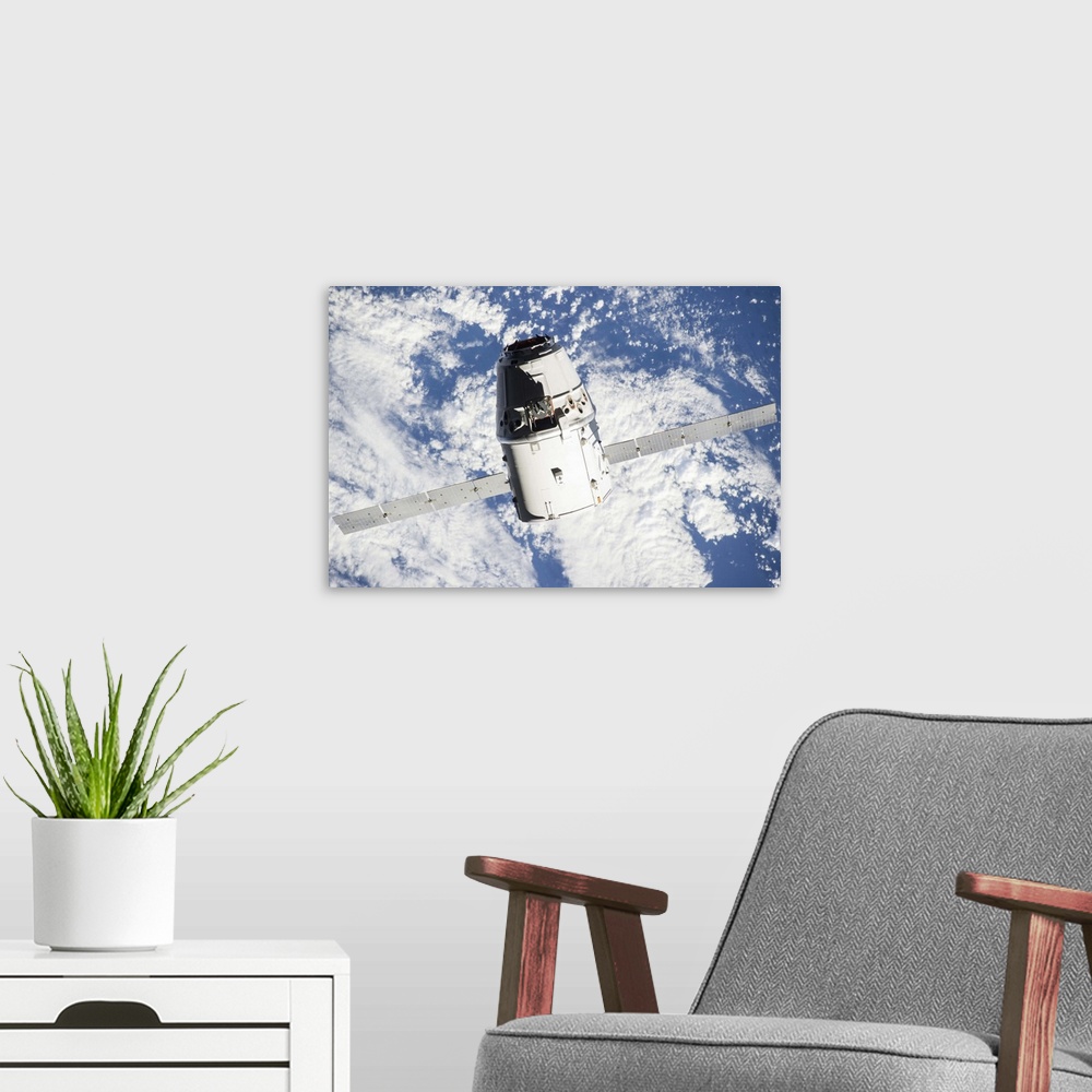 A modern room featuring September 23, 2014 - The SpaceX Dragon commercial cargo craft approaches the International Space ...