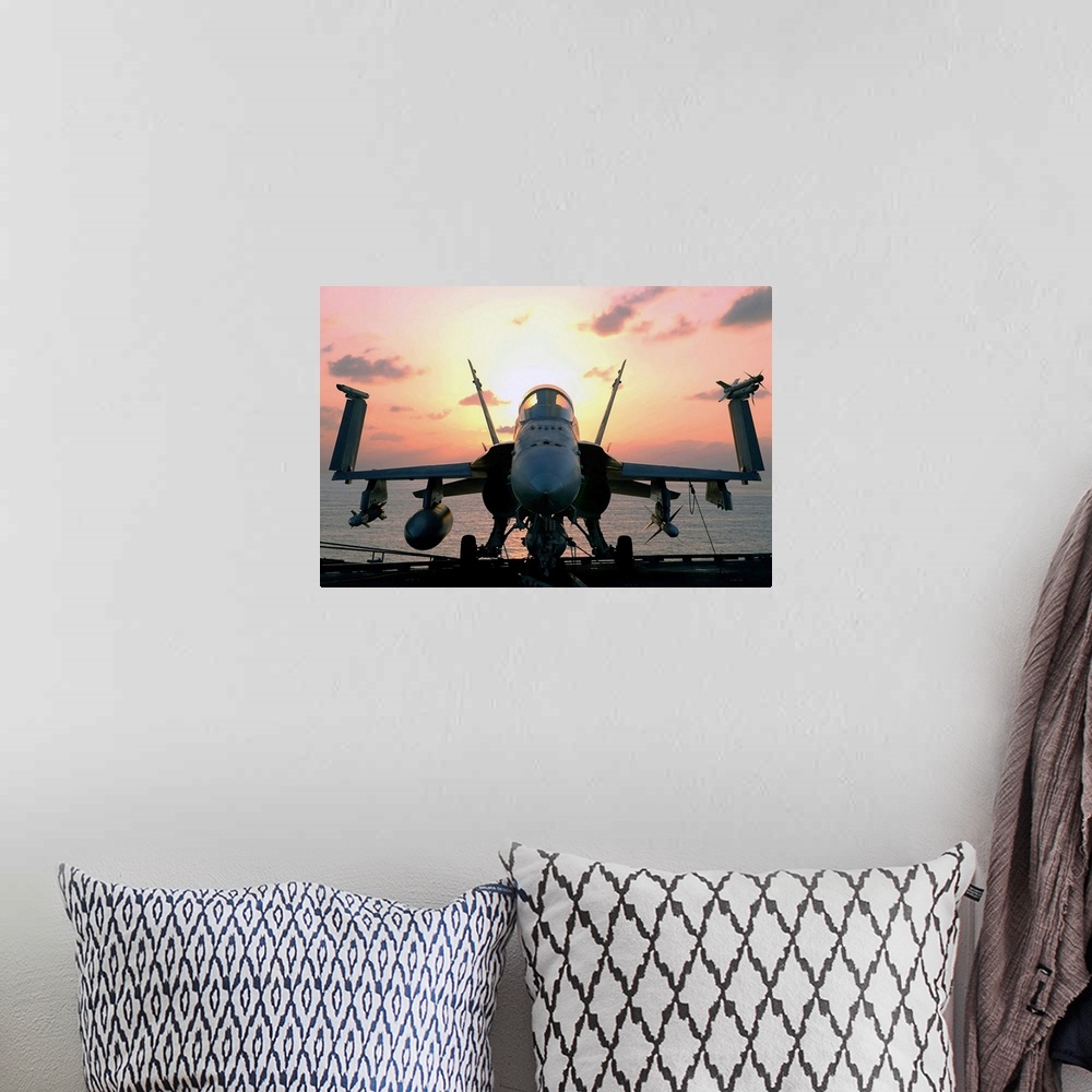 A bohemian room featuring Military photograph of a jet aircraft on the deck of a carrier ship, with wings folded up and the...