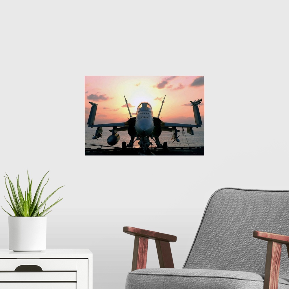 A modern room featuring Military photograph of a jet aircraft on the deck of a carrier ship, with wings folded up and the...