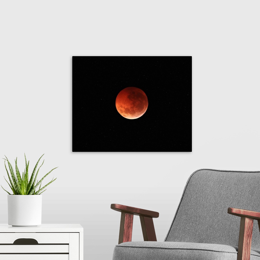 A modern room featuring The totality phase of a lunar eclipse during the 2010 solstice.