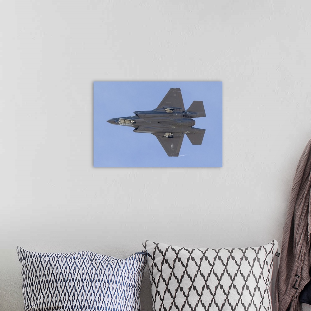 A bohemian room featuring The underside of a U.S. Air Force F-35A Lightning II as it turns on to final approach at Nellis A...
