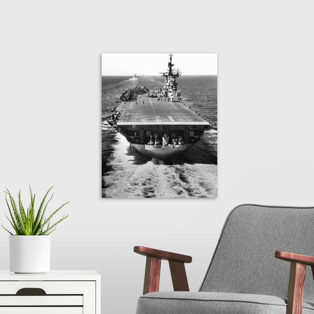 A modern room featuring The U.S. aircraft carrier USS Boxer operating off North Korea.
