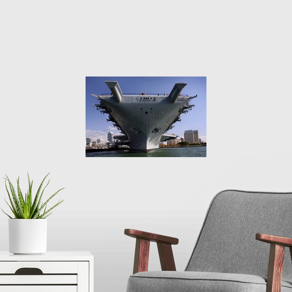 A modern room featuring The USS Midway berthed pierside