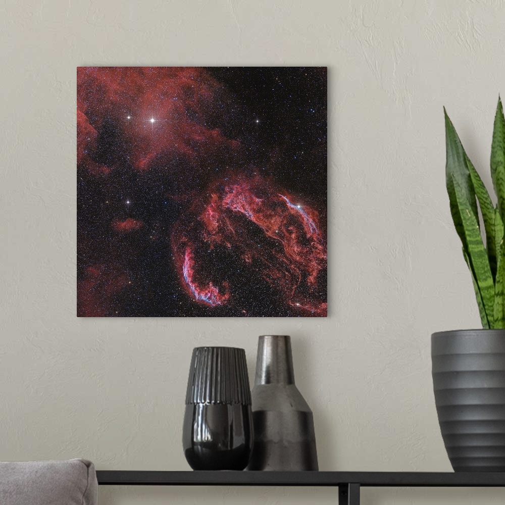 A modern room featuring The Veil Nebula in the constellation Cygnus glows red.