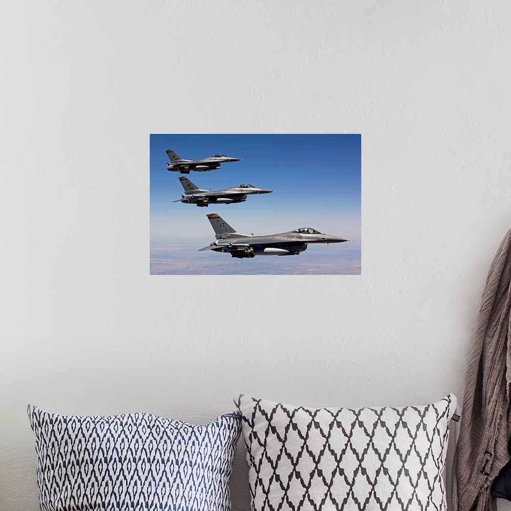 A bohemian room featuring Three F-16's from the Air National Guard Air Force Reserve Test Center fly in formation during a ...