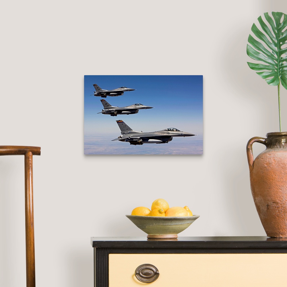 A traditional room featuring Three F-16's from the Air National Guard Air Force Reserve Test Center fly in formation during a ...